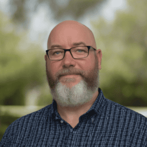 a man with a beard and glasses